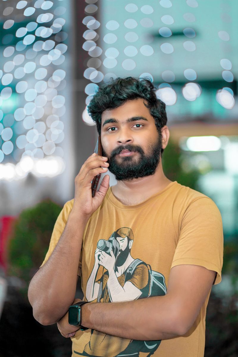 A young man making a phone call in the evening